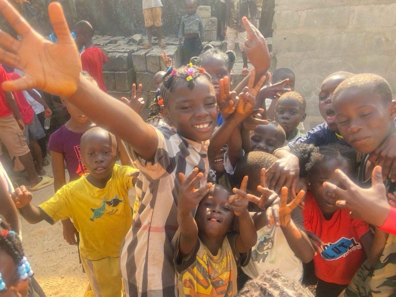 Children smiling during a Hands of Hope outreach activity in Sierra Leone