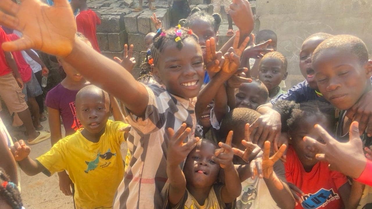Children smiling during a Hands of Hope outreach activity in Sierra Leone